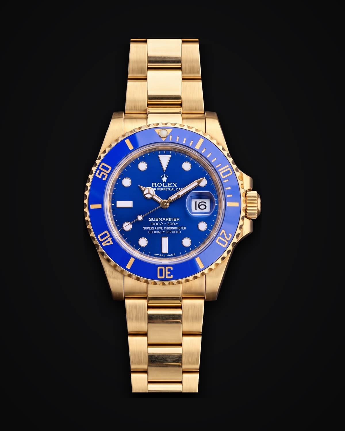 Gold dive watch with a blue dial and blue bezel on a gold bracelet